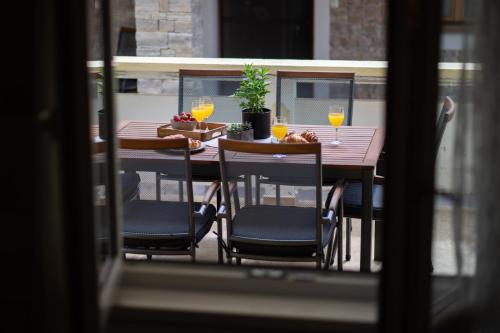 a table with chairs and wine glasses on a balcony at Holiday Home Ines in Vrsi