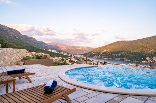 une grande piscine avec vue sur la ville dans l'établissement Apartments Villa Arcadia, à Dubrovnik