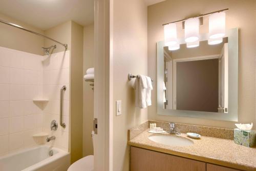 a bathroom with a sink and a toilet and a mirror at TownePlace by Marriott Suites Elko in Elko