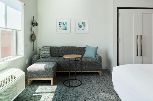 a living room with a couch and a table at TownePlace Suites by Marriott Hixson in Hixson