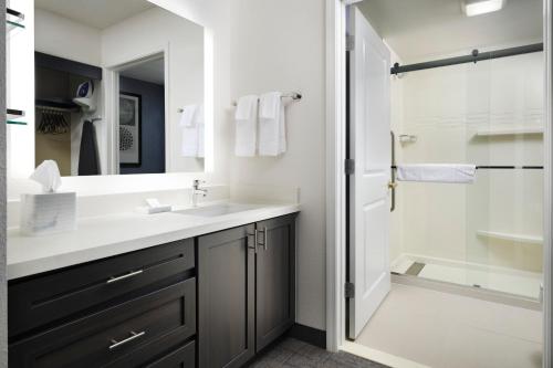 a bathroom with a sink and a shower at Residence Inn Mount Olive At International Trade Center in Stanhope