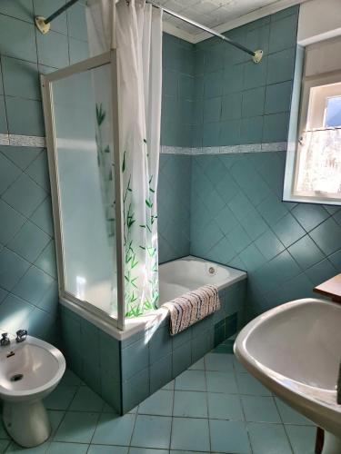a blue bathroom with a tub and a sink at Apartma Raft, Bovec in Bovec