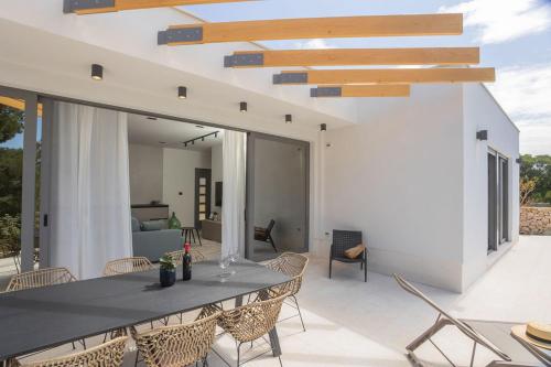 a patio with a table and chairs on a patio at Sullago in Šibenik