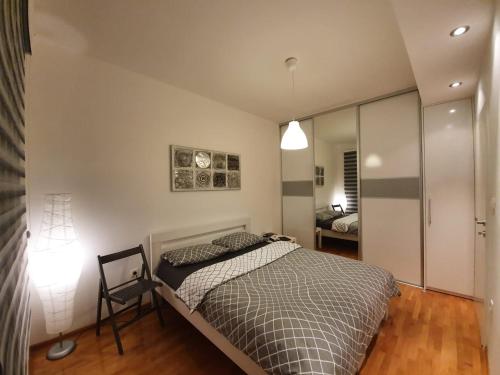 a bedroom with a bed and a mirror at Sunny home in Mostar with a garage! in Mostar
