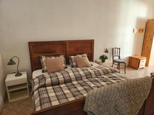 a bedroom with a large bed with a plaid blanket at Apartma Raft, Bovec in Bovec