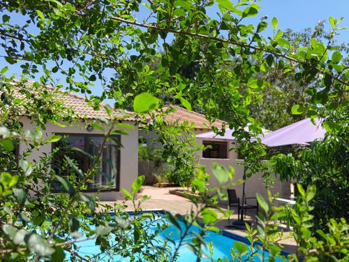 a view of a house through the trees at Nandoni Crystal in Thohoyandou