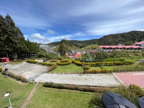 a garden in a resort with mountains in the background at Dear Dino Villa Cameron Highlands in Cameron Highlands