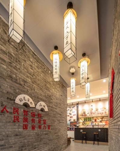 a restaurant with chinese signs on a brick wall at Riverside International Youth Hostel阅江老院青年旅舍 in Chongqing