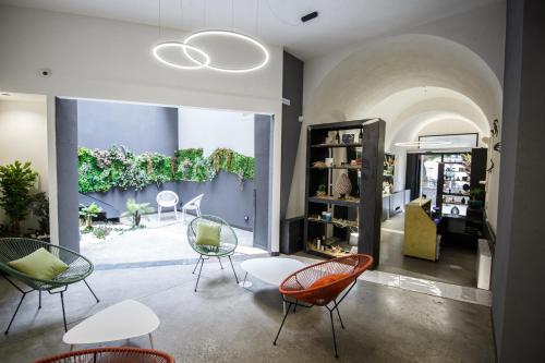 a store with chairs and tables in a room at MAZZINI PALACE in Misterbianco