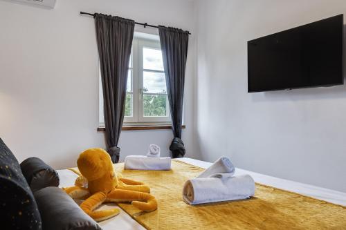 a living room with a table with stuffed animals on it at TEONA Luxury Apartment with 2 rooms and terrace sea view in Sali