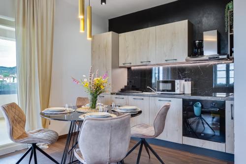 a kitchen with a table and chairs in a room at TEONA Luxury Apartment with 2 rooms and terrace sea view in Sali