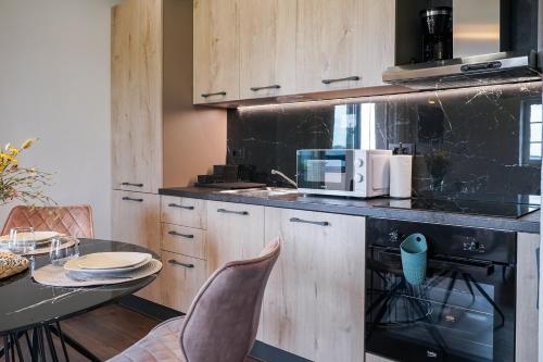 a kitchen with a black counter and a table at TEONA Luxury Apartment with 2 rooms and terrace sea view in Sali