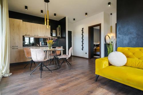 a living room with a yellow couch and a table at TEONA Luxury Apartment with 2 rooms and terrace sea view in Sali