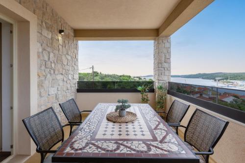 a patio with a table and chairs on a balcony at TEONA Luxury Apartment with 2 rooms and terrace sea view in Sali