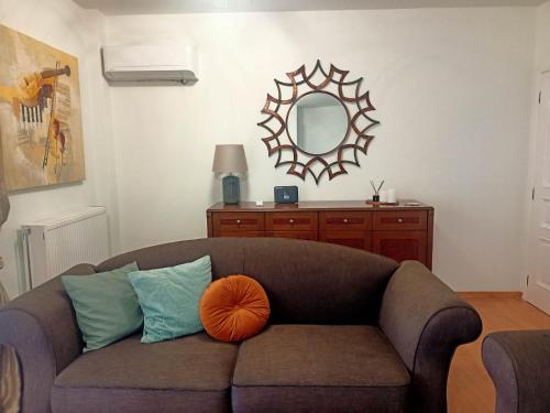 a living room with a couch and a mirror at DM Villa - quality stay in Perea, Thessaloniki, Greece in Perea