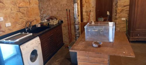 a kitchen with a sink and a washing machine at Beit el Deif in Jbeil