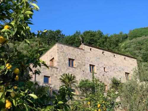an old stone building with trees in front of it at Holidays Homes The dream in Sant'Agnello