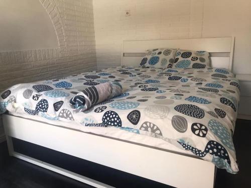 a bed with a comforter and pillows on it at Nice Entire Semi - Attached House - B in Umeå