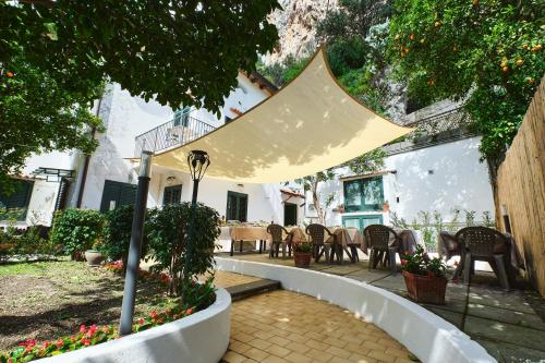 a patio with a tent and tables and chairs at Villa Fabiana in Amalfi