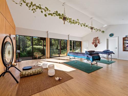 a bedroom with a bed in a room with windows at Simala Retreat in Cowaramup