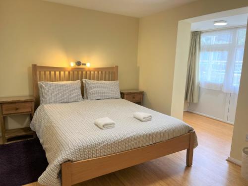 a bedroom with a bed with two towels on it at Ilex Lodge in St Peter Port