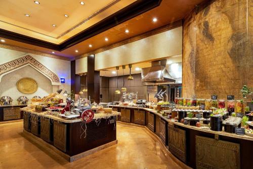a restaurant with a buffet line with food at Sharq Village & Spa, a Ritz-Carlton Hotel in Doha