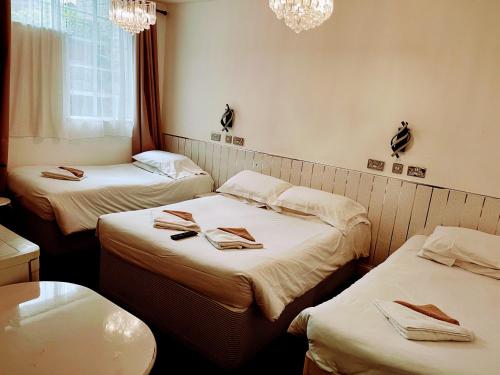 a room with two beds with towels on them at St George Hotel Great Yarmouth in Great Yarmouth