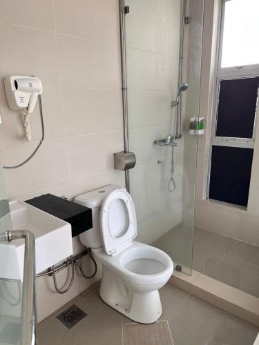 a bathroom with a toilet and a glass shower at Dear Dino Villa Cameron Highlands in Cameron Highlands