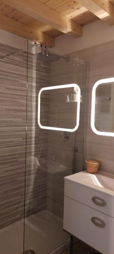 a shower with a glass door next to a sink at TRANI LA GRAZIA b&b in Trani
