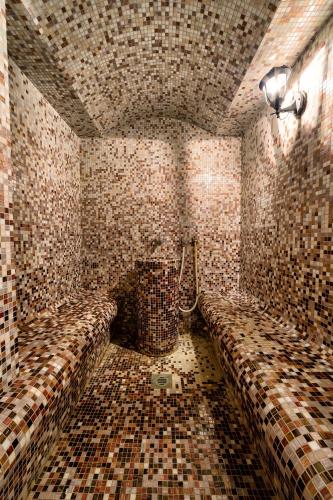 a tiled bathroom with a shower and a toilet at Villas Arausana & Antonina in Vodice