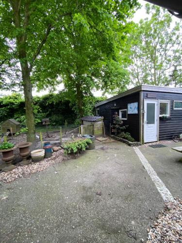 a small shed with a lot of plants in a yard at La Luna - Denise in Heerhugowaard