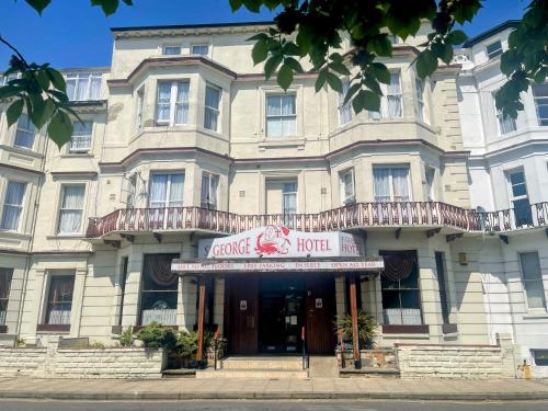 a large white building with a sign that reads grand hotel at St George Hotel Great Yarmouth in Great Yarmouth