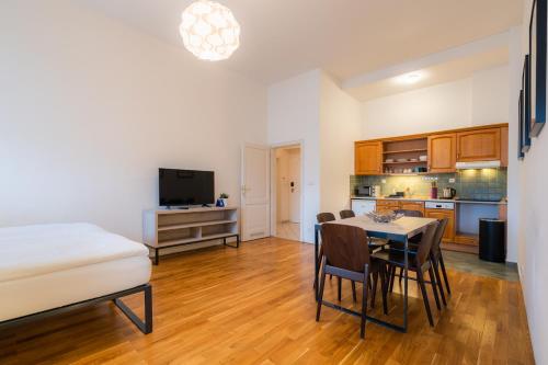 a kitchen and dining room with a table and chairs at EA ApartHotel Melantrich in Prague