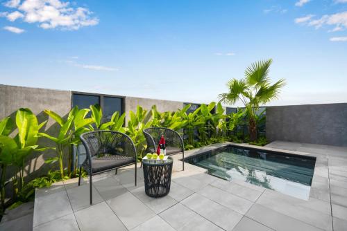 a patio with a swimming pool on a building at Estrella Boutique Hotel in Da Nang