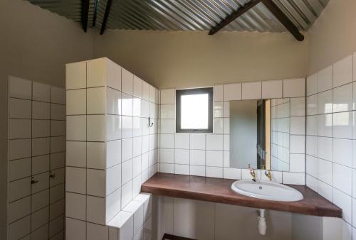 a bathroom with a sink and a mirror at Onguma Tamboti Campsite in Namutoni