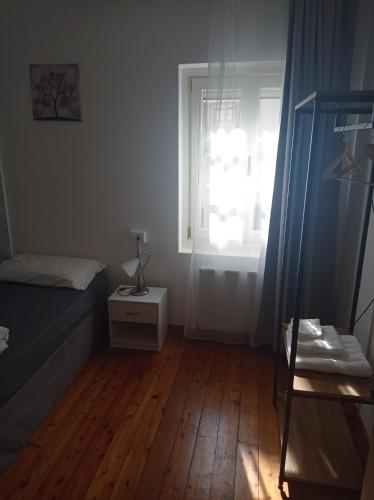 a small bedroom with a bed and a window at Affittacamere La Loggia in Venzone