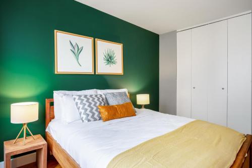 a bedroom with a green accent wall and a bed at 1BR nr Times Sq w Indoor pool Gym NYC-141 in New York