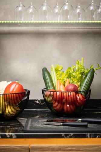 two red bowls filled with vegetables on a shelf at Hotel Donauhof in Deggendorf