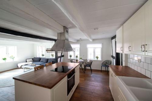 a kitchen and living room with a couch and a table at Entire house in the center in Ystad