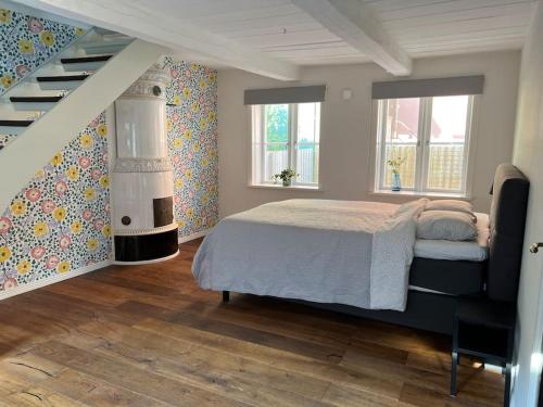 a bedroom with a bed and a staircase at Entire house in the center in Ystad