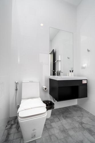 a white bathroom with a toilet and a sink at The Stay Huahin - Luxury Private Pool Villa in Khao Tao