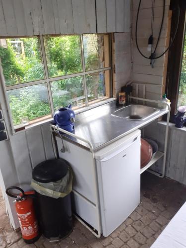 a small kitchen with a sink and a counter at Bauernhof-Offene Gartenhütte Grüne Oase Schlafsack in Hausbreitenbach