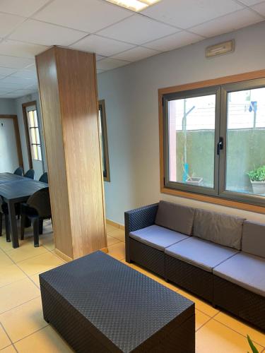 poczekalnia z kanapą i stołem w obiekcie HOSTEL Cangas w mieście Cangas de Morrazo