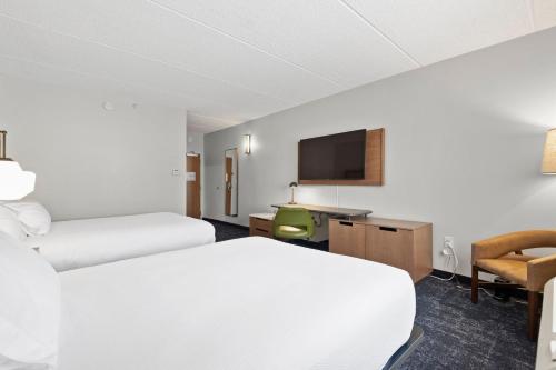 a hotel room with two beds and a flat screen tv at Fairfield Inn & Suites by Marriott Hickory in Hickory