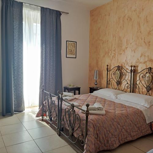 a bedroom with a large bed and a window at Mediterraneo Camere in Otranto