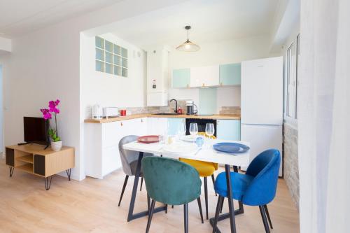 une cuisine avec une table et des chaises bleues dans l'établissement EDOUARD VII - STUDIO - Carré d'or Menton, à Menton