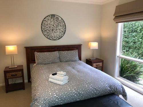 a bedroom with a bed with towels on it at Grand Escape McKenzie - solar heated Pool, WiFi, Netflix, 5 bdrm, 4bthrm in Cowes