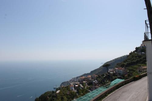 a view of a town on a hill next to the water at Vent In Costa Ospitalità Diffusa in Furore