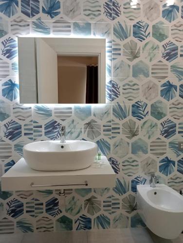 a bathroom with a sink and a mirror at Rosy's House in Scafati