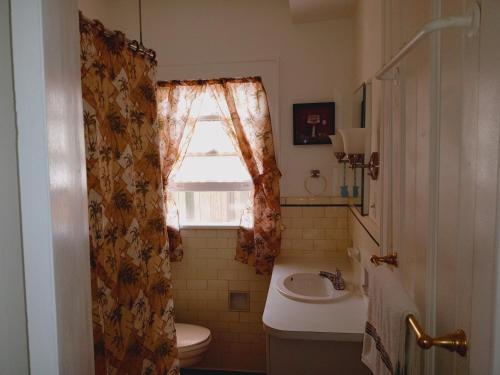 a bathroom with a sink and a toilet and a window at Mini Mansion Hotel affordable stays Plainfield NJ near public transportation in Plainfield